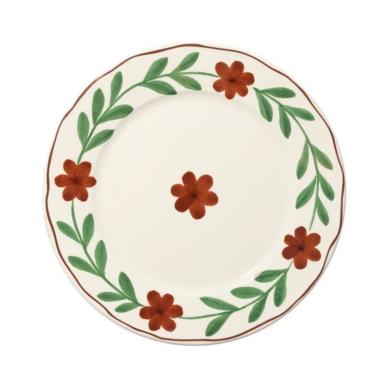 Plato pintado, flores de terracota y hojas verdes